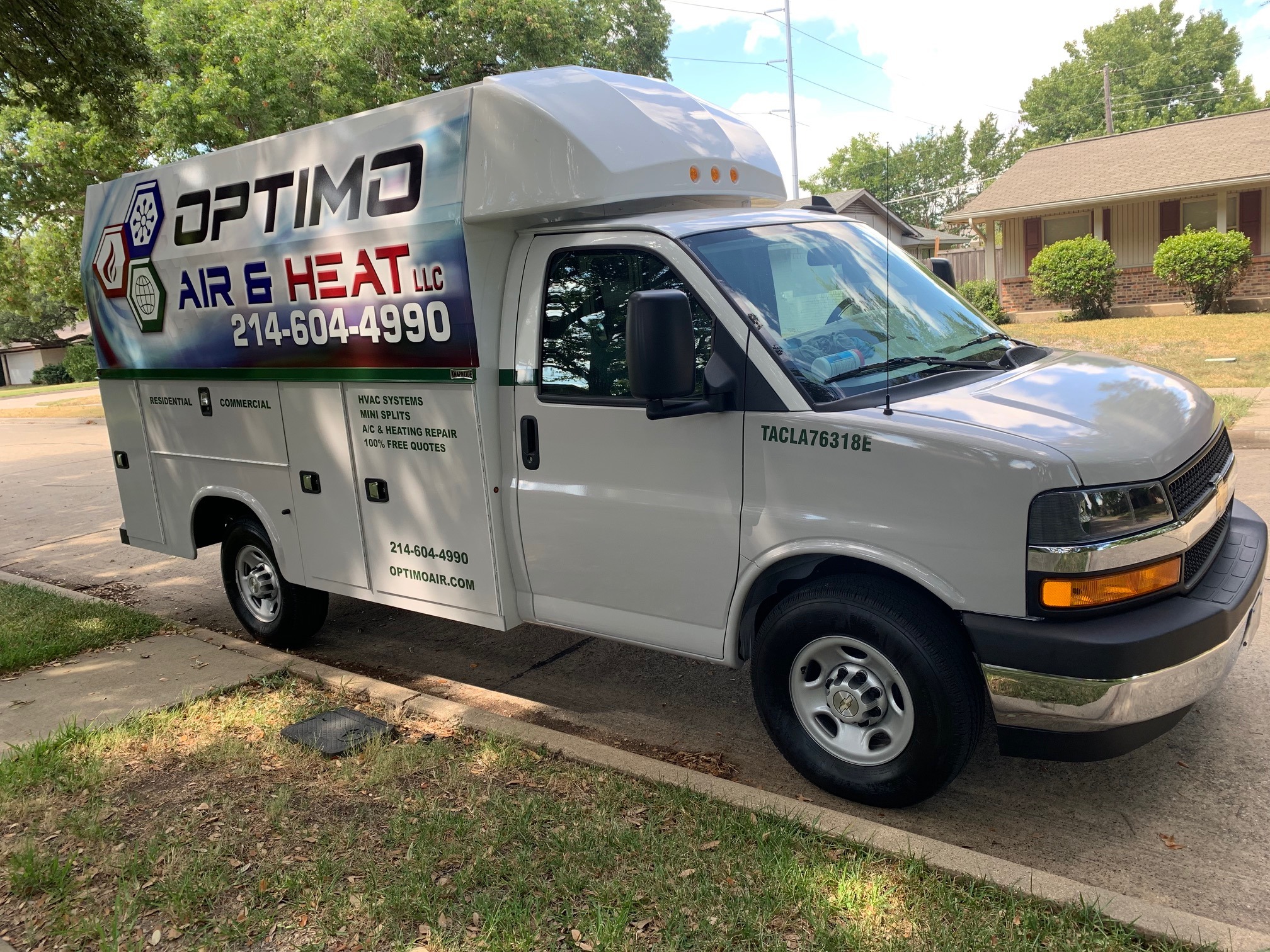 A white truck parked on the side of a road